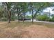 This charming home features a covered porch, an oversized lot, and mature trees at 424 Eden Park Rd, Altamonte Springs, FL 32714