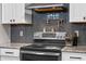 Close-up view of a modern range and tile backsplash in a bright, renovated kitchen at 424 Eden Park Rd, Altamonte Springs, FL 32714