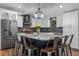 Renovated kitchen island with modern appliances, a breakfast bar, and granite countertops at 424 Eden Park Rd, Altamonte Springs, FL 32714