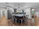 Open kitchen and dining area with modern island, stainless steel appliances and wood floors at 424 Eden Park Rd, Altamonte Springs, FL 32714