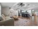 Open-concept living room with wood floors, a ceiling fan, and views of the kitchen at 424 Eden Park Rd, Altamonte Springs, FL 32714