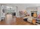 Spacious playroom with hardwood flooring and fireplace opens to the dining area with seating at 424 Eden Park Rd, Altamonte Springs, FL 32714