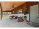 This covered porch features wicker furniture and a painted brick foundation at 424 Eden Park Rd, Altamonte Springs, FL 32714