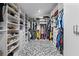 Large walk-in closet with organized shelving and storage, featuring geometric tile flooring at 424 Eden Park Rd, Altamonte Springs, FL 32714