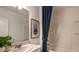 Stylish bathroom featuring a shower-tub combo with a curtain, vanity with plant, and decorative art at 4557 Ranunculus St, Haines City, FL 33844