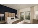 Inviting bedroom with large windows, stylish lamps, and a comfortable bed with decorative pillows at 4557 Ranunculus St, Haines City, FL 33844
