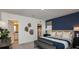 Stylish bedroom with ensuite bathroom and closet, with a blue accent wall and comfortable bed at 4557 Ranunculus St, Haines City, FL 33844
