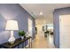 Hallway leading to an open-concept living area with tiled floors and recessed lighting at 4557 Ranunculus St, Haines City, FL 33844