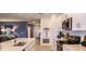 Bright kitchen with white cabinets, stainless steel appliances, and an open layout at 4557 Ranunculus St, Haines City, FL 33844