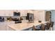 Modern kitchen with stainless steel appliances, white cabinets, and a spacious island with seating at 4557 Ranunculus St, Haines City, FL 33844