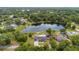 An aerial view showing a home on a large lot with a pond and lush greenery at 51 Spruce Ln, Debary, FL 32713