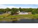 Back of house with nice lake, green grass and lots of trees in the background at 51 Spruce Ln, Debary, FL 32713
