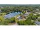 Stunning aerial view of lakefront house, showcasing expansive natural beauty and serene neighborhood at 51 Spruce Ln, Debary, FL 32713