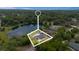 An aerial view showcasing the property's location near a pond, surrounded by abundant trees at 51 Spruce Ln, Debary, FL 32713
