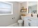 This bright bathroom has stylish shelving and decor at 51 Spruce Ln, Debary, FL 32713