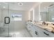 Bright bathroom featuring double sink vanity and glass shower at 51 Spruce Ln, Debary, FL 32713