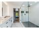Stylish bathroom featuring double sinks, tile flooring, and a glass shower at 51 Spruce Ln, Debary, FL 32713