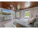 Bedroom boasts hardwood ceilings, large windows, and a mounted tv with dresser at 51 Spruce Ln, Debary, FL 32713