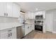 Bright kitchen featuring white cabinets, stainless steel appliances, and modern countertops at 51 Spruce Ln, Debary, FL 32713