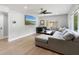 Comfortable living room featuring a large sectional sofa, wood flooring, and a ceiling fan at 51 Spruce Ln, Debary, FL 32713