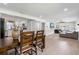 Open-concept living space with wood floors connecting the dining area, living room, and kitchen at 51 Spruce Ln, Debary, FL 32713