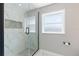 Modern shower with white tiled walls and dark hex flooring at 51 Spruce Ln, Debary, FL 32713