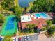 Stunning aerial view of community clubhouse, pool, tennis court, and lake at 5112 Conroy Rd # 13, Orlando, FL 32811