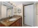 This bathroom features granite countertops, a white sink, and dark brown cabinets at 5112 Conroy Rd # 13, Orlando, FL 32811