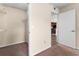 Carpeted walk-in closet showing wire shelving with view to kitchen with stainless steel appliances and dark cabinetry at 5112 Conroy Rd # 13, Orlando, FL 32811