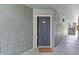 A welcoming entrance featuring a classic dark-colored door with a cozy welcome mat at 5112 Conroy Rd # 13, Orlando, FL 32811