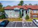 Charming condo exterior with a red tile roof and well-maintained landscaping in a desirable community at 5112 Conroy Rd # 13, Orlando, FL 32811