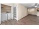 Convenient laundry area with washer, dryer, and storage shelves, located near the living space at 5112 Conroy Rd # 13, Orlando, FL 32811