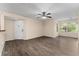This living room features wood look floors, neutral walls, white trim and front door and large windows at 5112 Conroy Rd # 13, Orlando, FL 32811