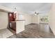 Bright living space with wood-look floors flowing into an open kitchen, plus a ceiling fan at 5112 Conroy Rd # 13, Orlando, FL 32811