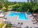 Refreshing community pool surrounded by lounge chairs at 5112 Conroy Rd # 13, Orlando, FL 32811