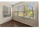 This sunroom has wood-look floors, neutral walls and windows with outdoor view at 5112 Conroy Rd # 13, Orlando, FL 32811
