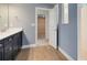 Bathroom with double vanity, tile floors, leading to a walk-in closet and walk-in shower at 5262 Foothills Preserve Loop, Mount Dora, FL 32757