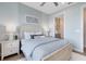 Light-filled bedroom with a comfortable bed, neutral decor, and an en-suite bathroom, offering a private retreat at 5262 Foothills Preserve Loop, Mount Dora, FL 32757