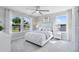 Bedroom with a large window, ceiling fan, and comfortable bedding at 5262 Foothills Preserve Loop, Mount Dora, FL 32757
