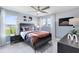 Bedroom features a sports theme with a large window, ceiling fan, and comfortable furniture at 5262 Foothills Preserve Loop, Mount Dora, FL 32757