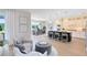 Open-concept kitchen and dining area with pendant lighting, large island with seating, and plenty of natural light at 5262 Foothills Preserve Loop, Mount Dora, FL 32757