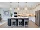 Well-lit kitchen featuring a central island with seating, stainless appliances, and pendant lighting at 5262 Foothills Preserve Loop, Mount Dora, FL 32757