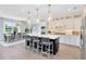 Bright kitchen with a central island, pendant lighting, stainless appliances, and views of the dining area at 5262 Foothills Preserve Loop, Mount Dora, FL 32757