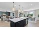 Spacious kitchen with island and sink, leading into the living room and dining area, creating an open-concept space at 5262 Foothills Preserve Loop, Mount Dora, FL 32757
