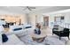 Inviting living room with open layout, modern furnishings, and views into the kitchen and dining area at 5262 Foothills Preserve Loop, Mount Dora, FL 32757