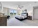 Spacious bedroom featuring a large bed, ceiling fan, and view to exterior at 5262 Foothills Preserve Loop, Mount Dora, FL 32757