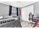 Cozy bedroom with ample natural light, closet space, and wood-look flooring at 5904 Lakewood Ln, Lakeland, FL 33805