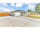 Charming single-story home featuring a well-maintained lawn, attached garage, and neutral exterior paint at 5904 Lakewood Ln, Lakeland, FL 33805