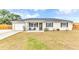 Charming single-story home featuring a well-manicured lawn and a cozy front porch seating area at 5904 Lakewood Ln, Lakeland, FL 33805
