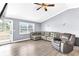 Bright living room with a comfortable sofa, natural light, and wood-look flooring at 5904 Lakewood Ln, Lakeland, FL 33805
